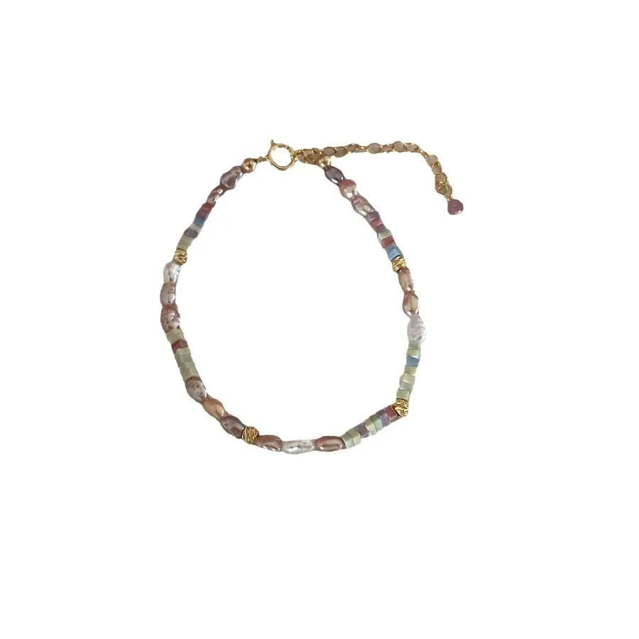 Natural pearl bracelet and necklace set with small irregular pearls and 14K gilded purple silver finish.