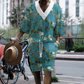 Men's peacock blue knitted casual shorts suit with T-shirt top on a plain background.