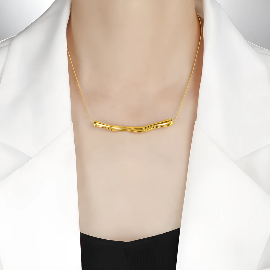 Close-up of a titanium steel women's necklace with an irregular pleated design in a gold electroplated finish.