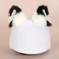 Plush fabric cartoon character helmet cover stretched over a blue hat for children's dress-up.