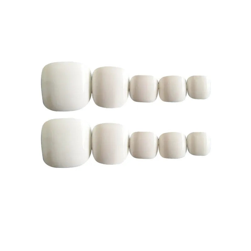 White artificial false toe nails with starry sky pattern, shown as a complete set with glue.