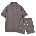 A woman's two-piece co-ord set with a short sleeve top and elastic waist shorts in a neutral colour.