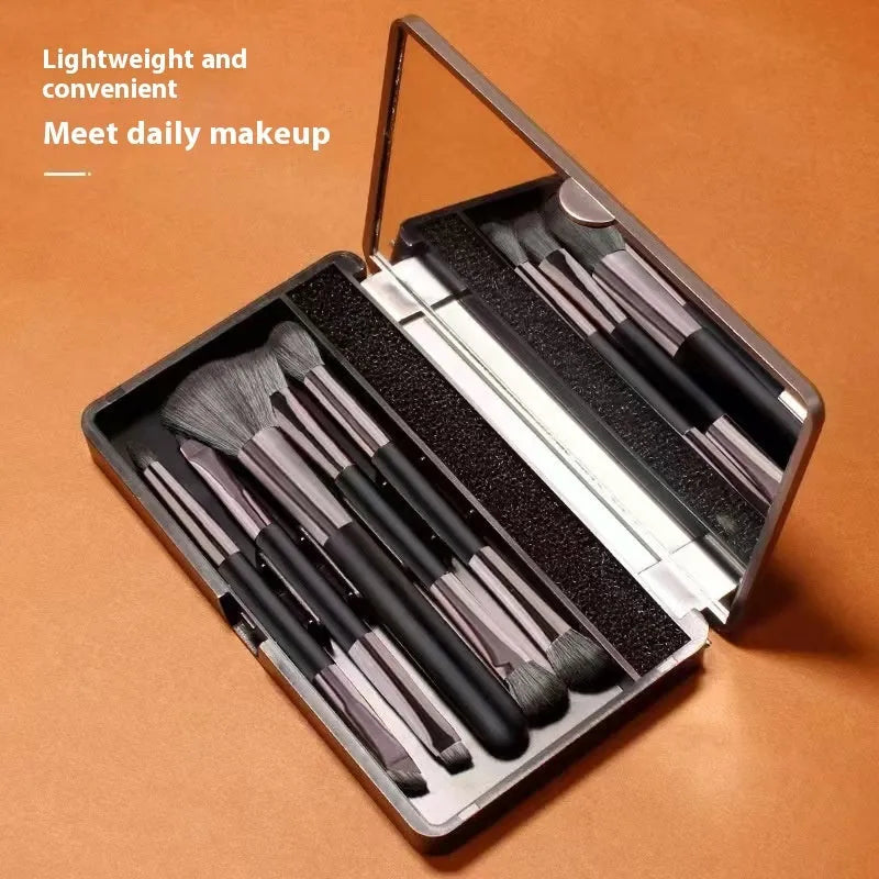 Makeup brush set with mirror showing plastic handles and artificial fibre bristles