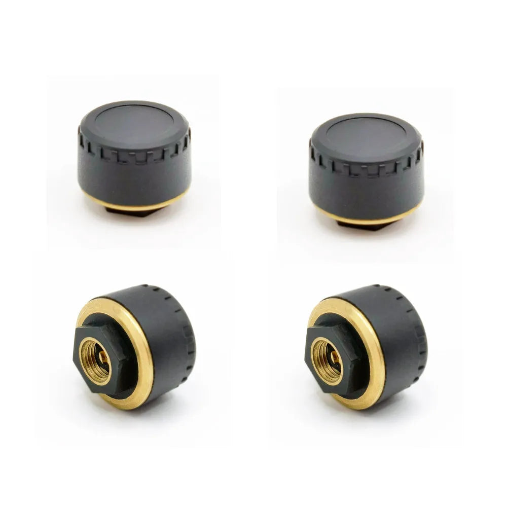 Four black Bluetooth tyre pressure sensors for car wheel monitoring via mobile phone app