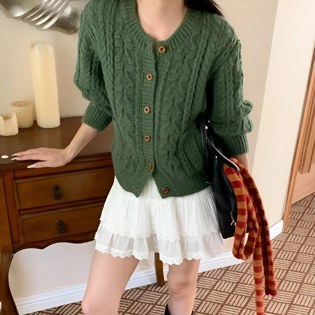 Solid colour thick needle twisted texture knitted cardigan in beige, short length, on model
