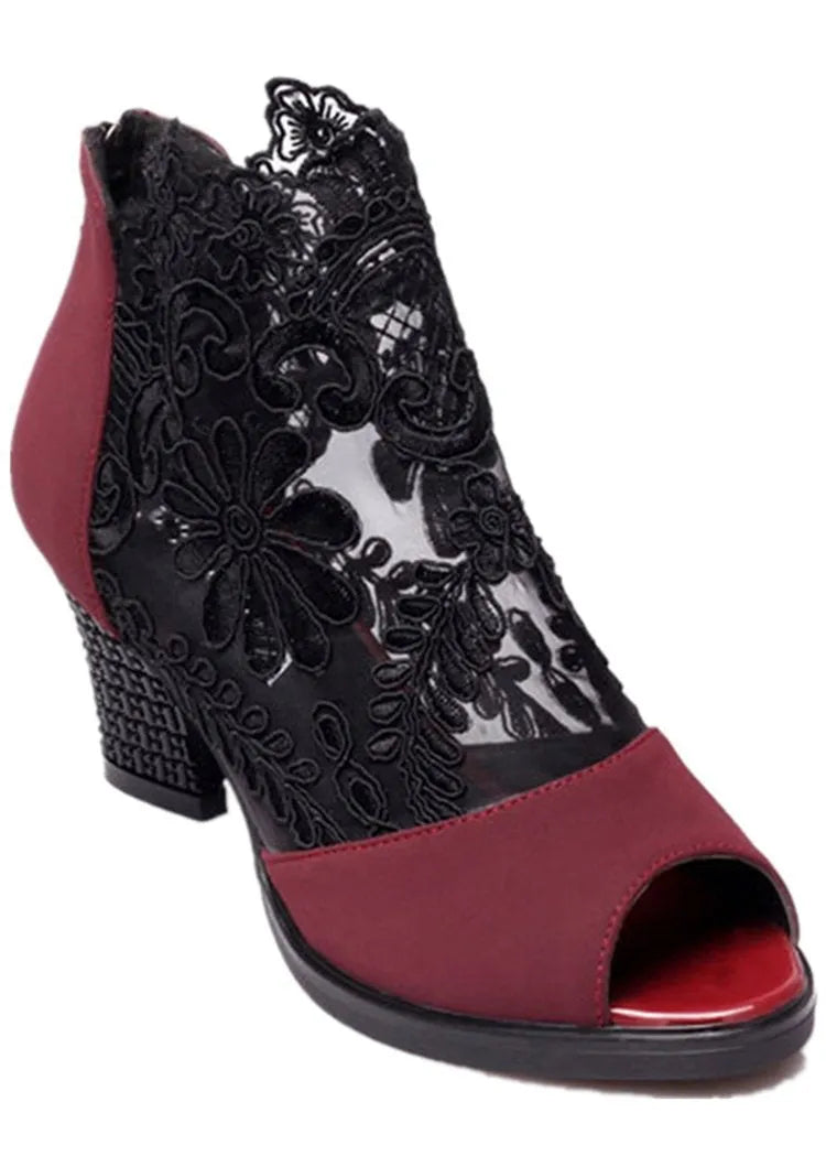 Women's black lace gladiator sandals with square heels and floral patterns, showing zip closure and peep toe design