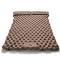 Dark blue double air mattress with built-in pump inflated on a floor, showing integrated pillow.
