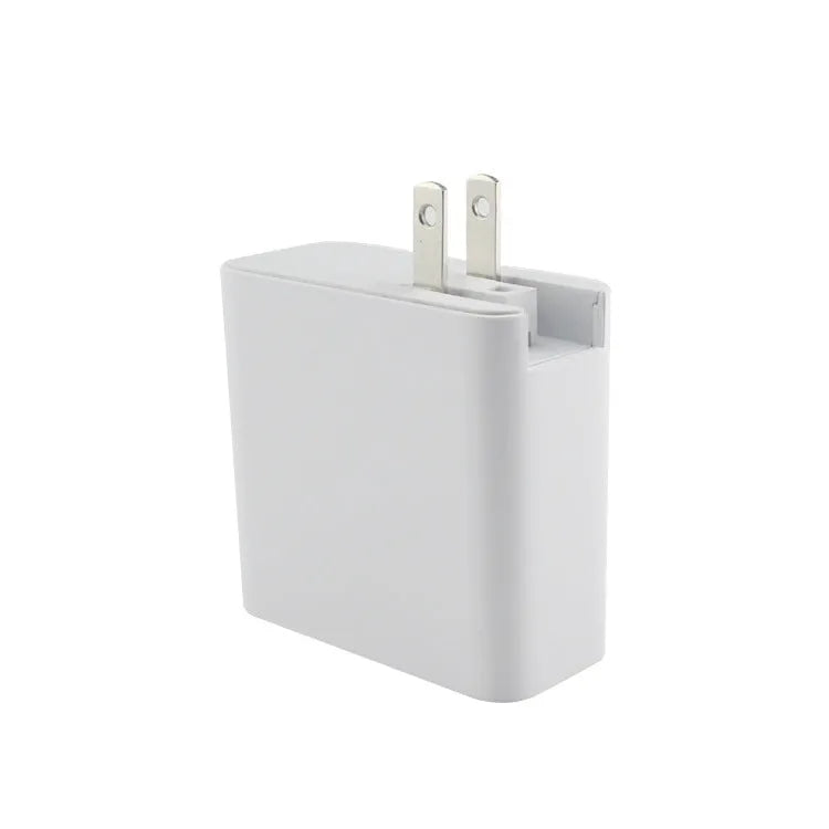 Black 48W desktop charger with four USB-C ports and a white UK plug on a wooden table.