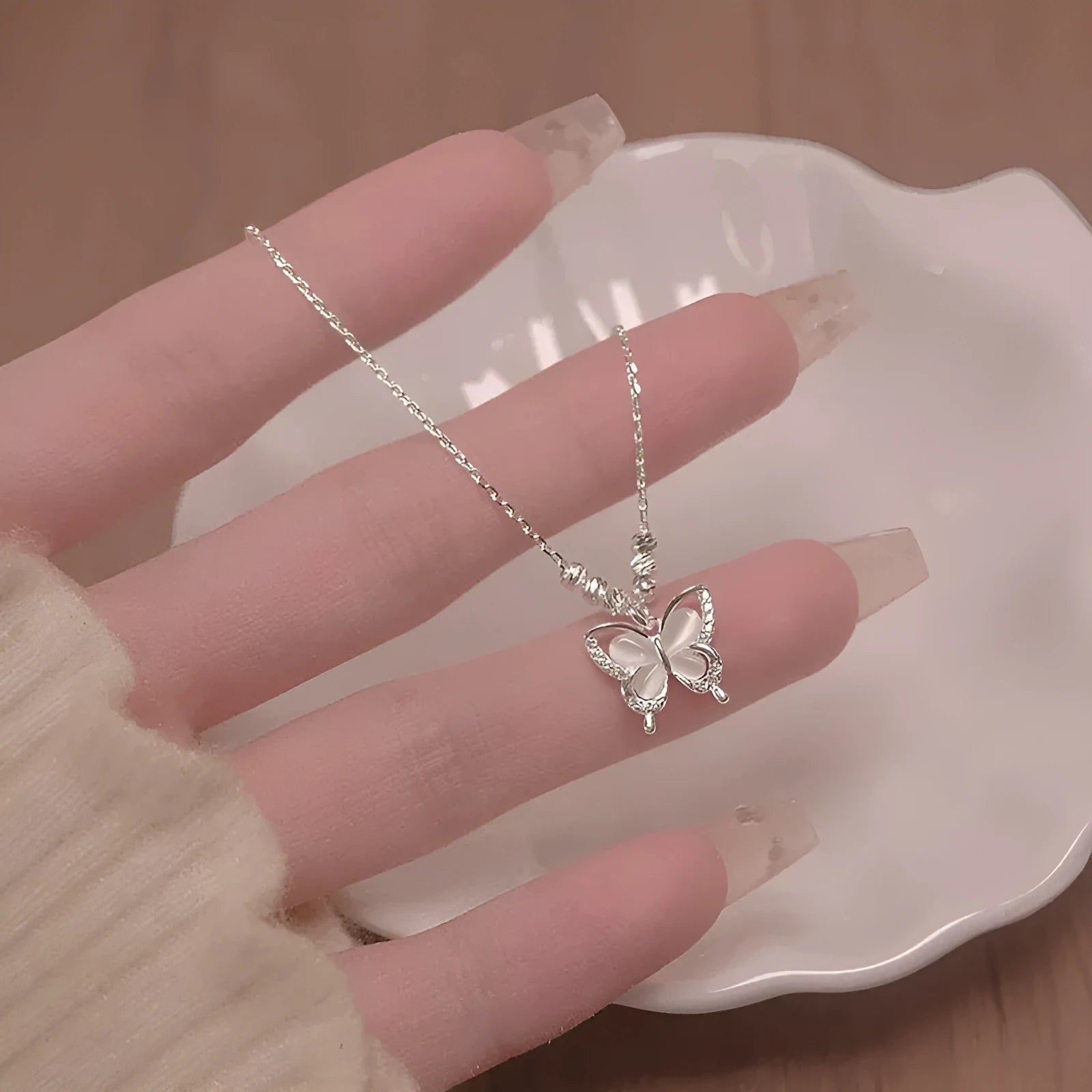 Silver women's butterfly necklace with square line opal pendant on an adjustable cross chain.