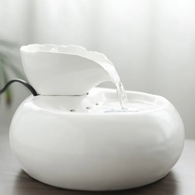 White porcelain leaf-shaped automatic cat water dispenser on floor