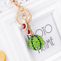 Green watermelon-shaped metal keychain made from zinc alloy, measuring 12 cm.