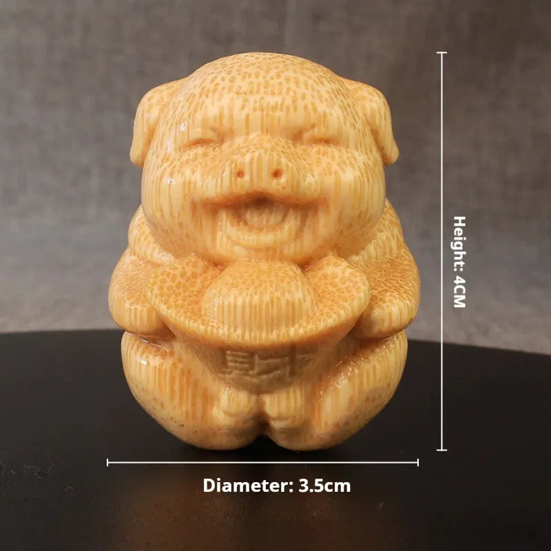 Solid bamboo carving ornament of pig ingot measuring 4cm tall by 3.5cm wide