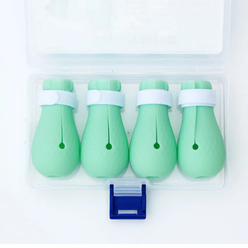 Set of four green silicone covers designed to fit over a cat's front paws.