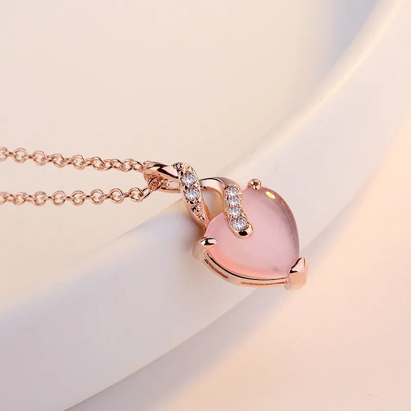 Women's heart-shaped pink artificial crystal pendant necklace on rose gold cross chain