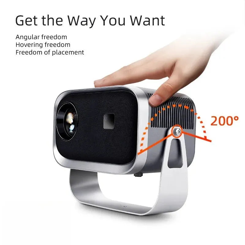 Portable 4K smart home theatre projector unit on a table, showing compact design and lens.