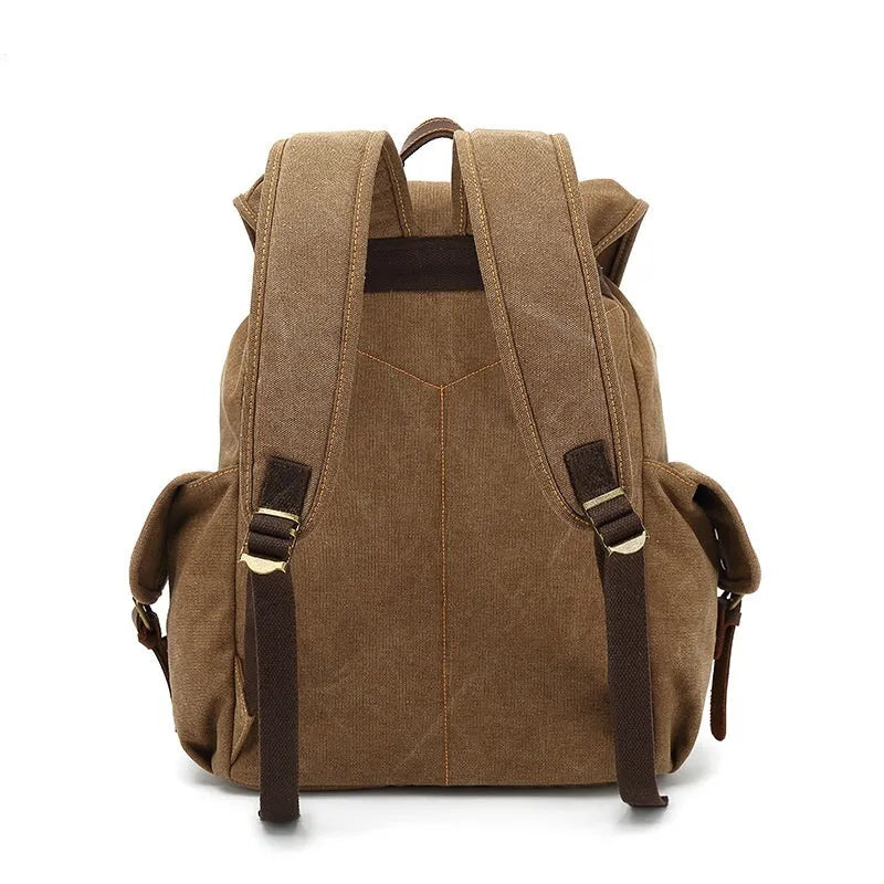 Retro canvas backpack in military green with antique bronze hardware showing front compartment organisation