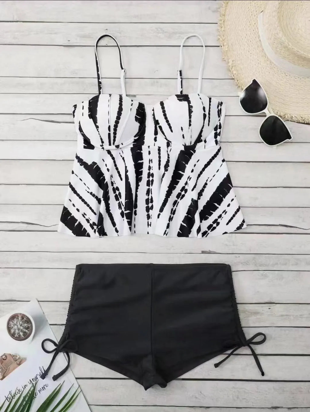 Women's white, blue, and purple polyester bikini swimsuit with matching top and shorts.
