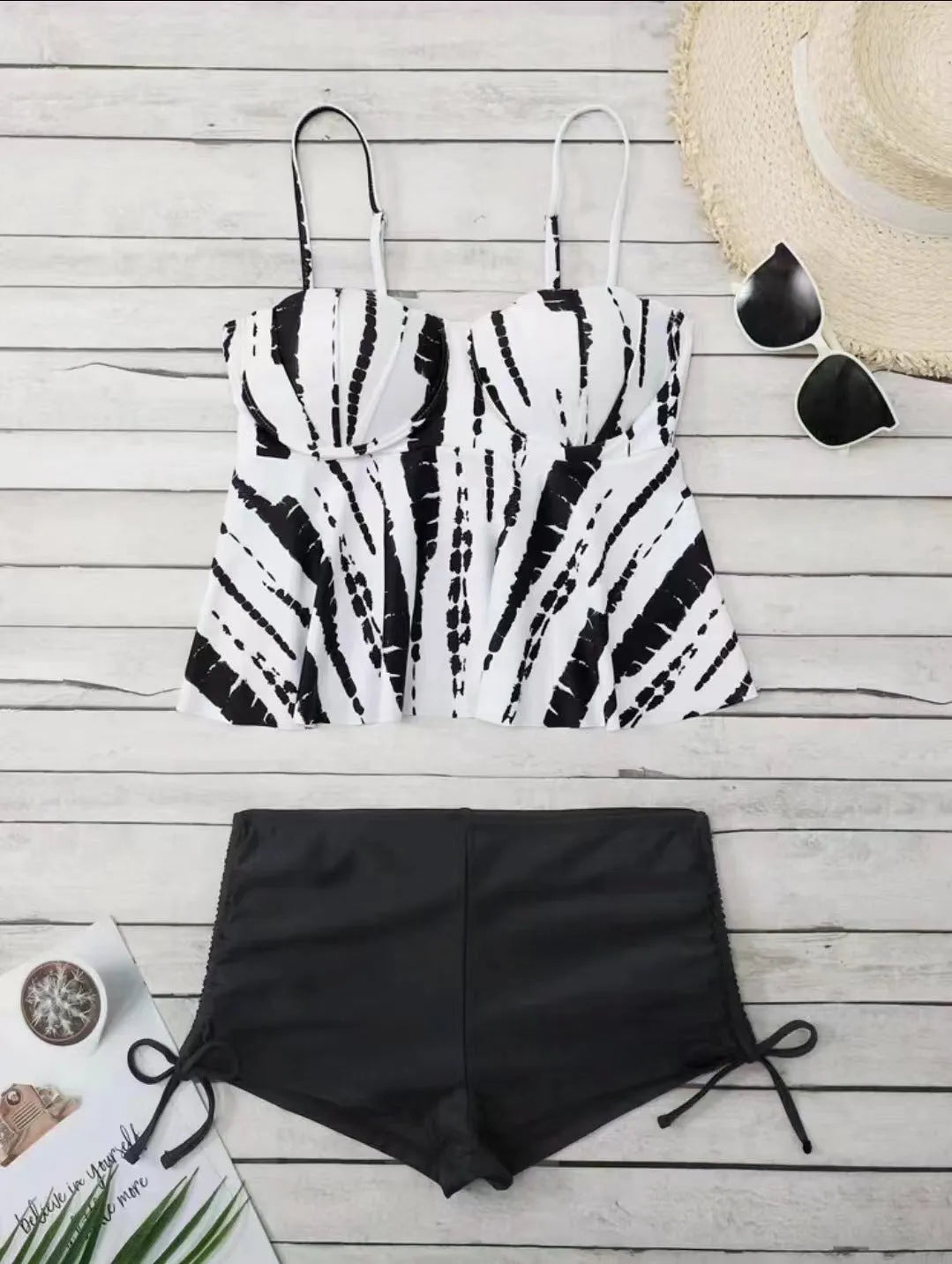 Women's white, blue, and purple polyester bikini swimsuit with matching top and shorts.