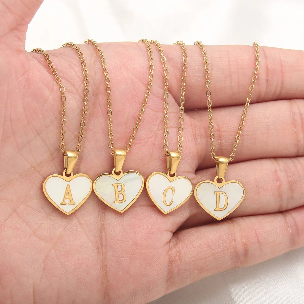 Gold plated heart-shaped white shell necklace with personalised text on a stainless steel chain.