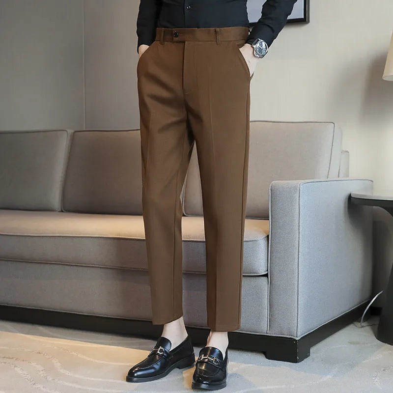 Straight-leg brown corduroy trousers with an elastic waistband laid flat.