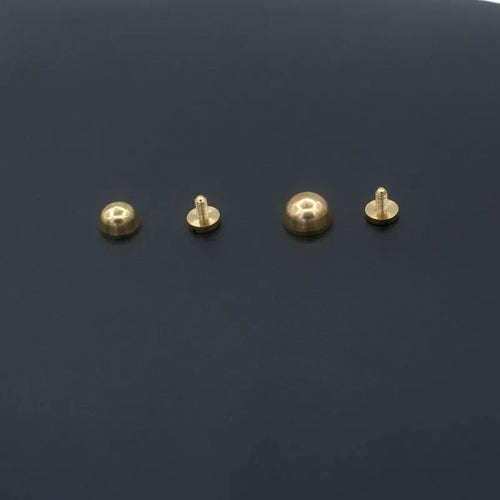 Brass decorative buckle foot nails in round and bucket head shapes, sizes 10x6mm and 12x7mm.