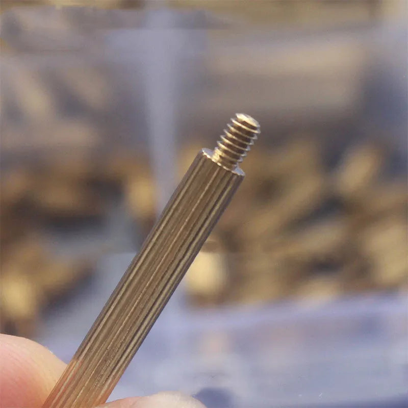 Gold-coloured 260-piece stainless steel screw nut and brass copper column set stored in a clear compartment box