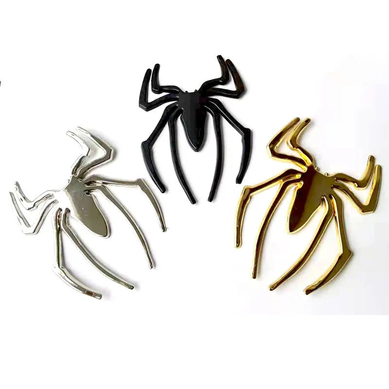 Three-dimensional metal spider bumper sticker in gold colour on vehicle surface
