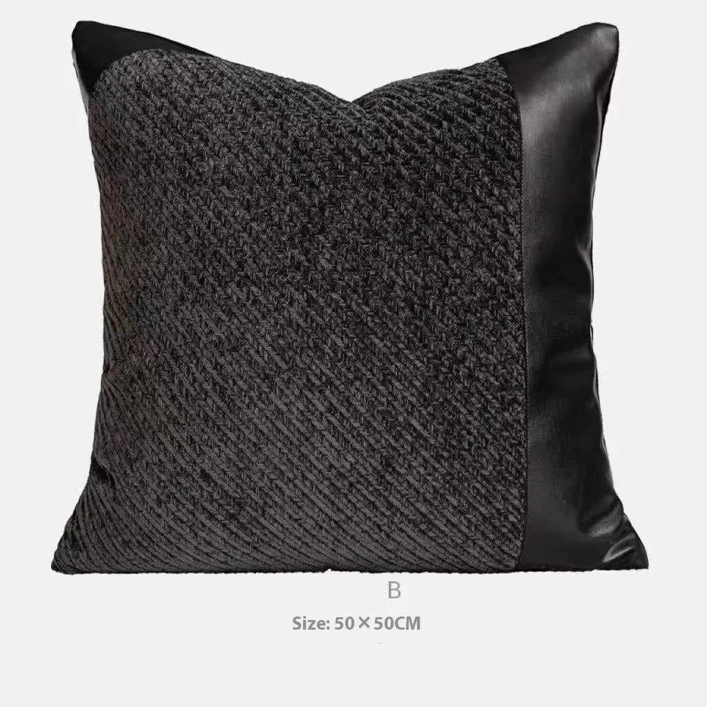 Modern gray and white plaid bed runner blanket with matching pillowcase and round leather-look pillow on a bed.