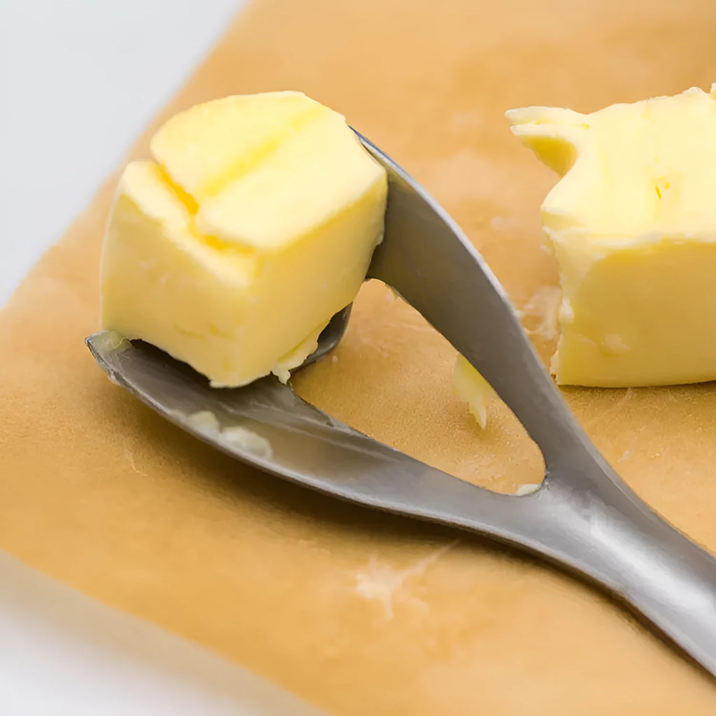 Stainless steel butter cutter with 12cm 304 stainless steel edged blade on a kitchen surface