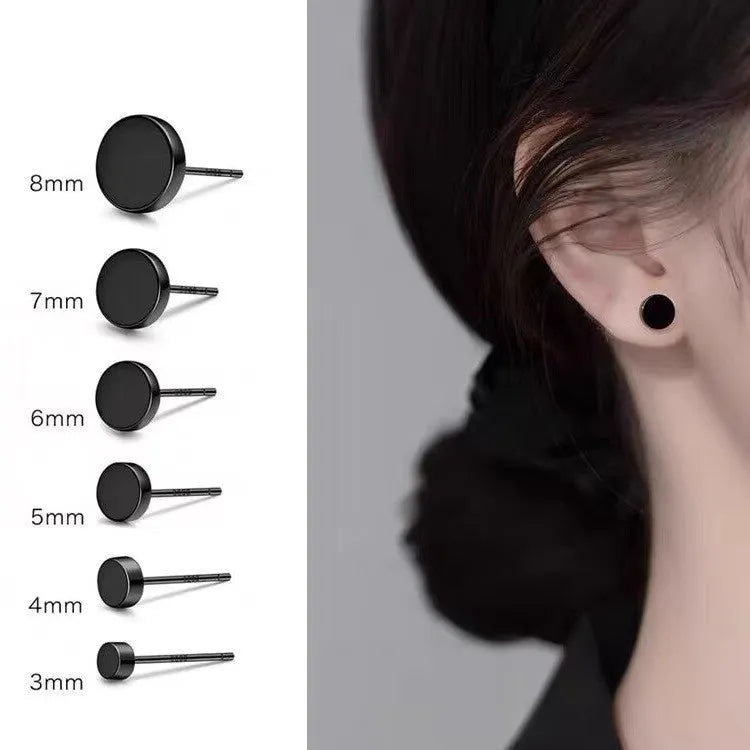 A pair of round, flat bone stud earrings in sterling silver, showing silver and black colour options.