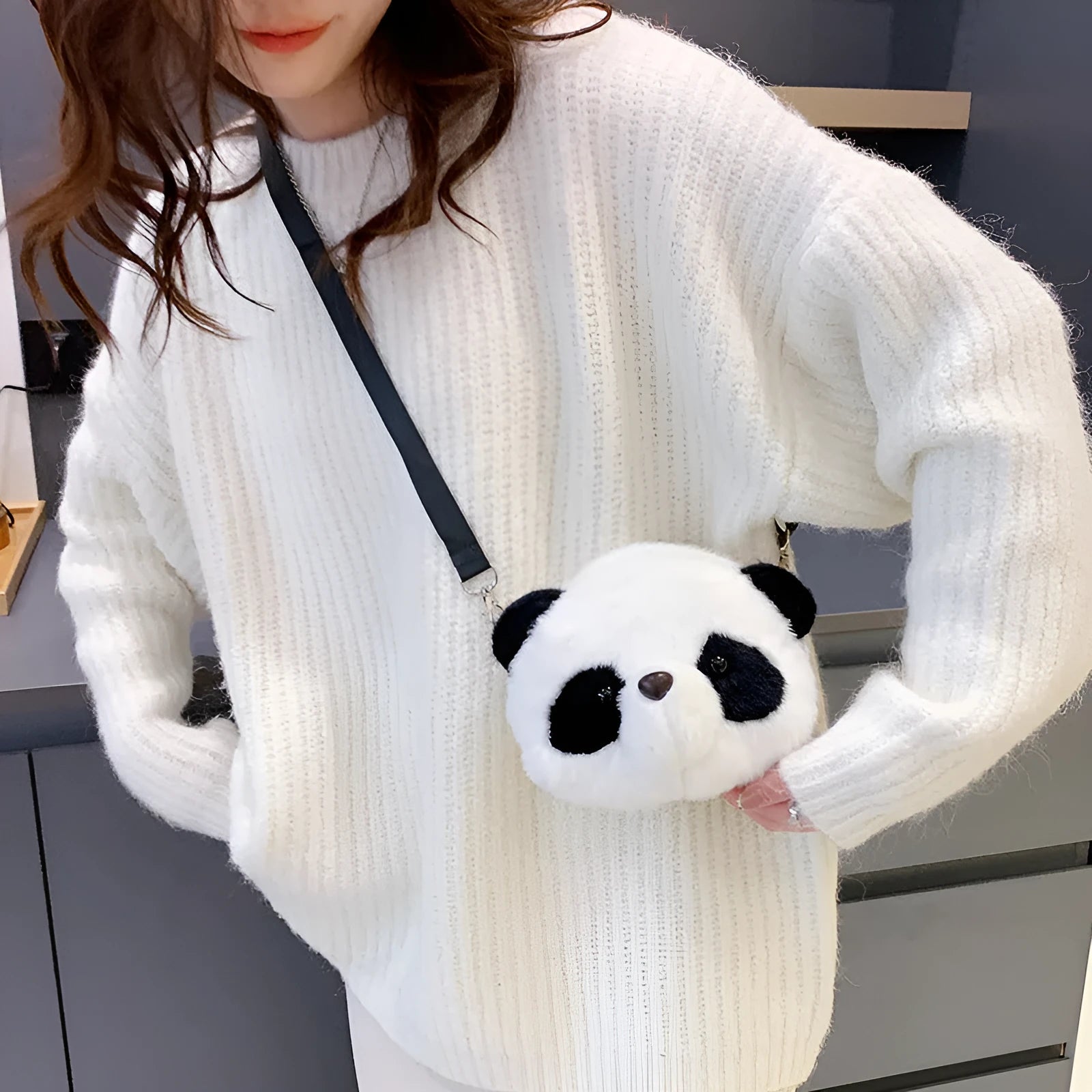 Soft cylindrical plush crossbody bag with panda head design, showing front sandwich pocket.