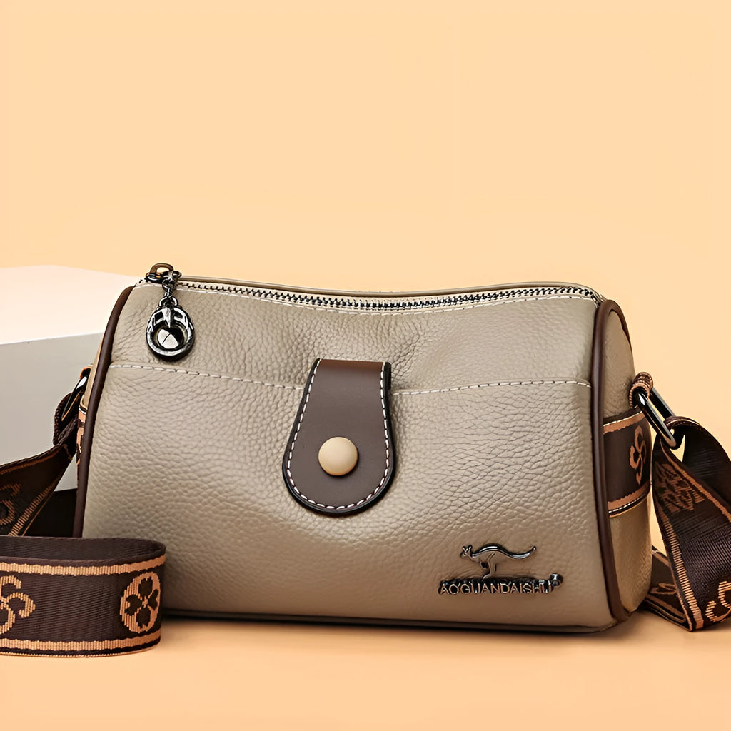 Women's top grain leather crossbody bag in blue, black, or khaki with horizontal square shape and inner pockets.