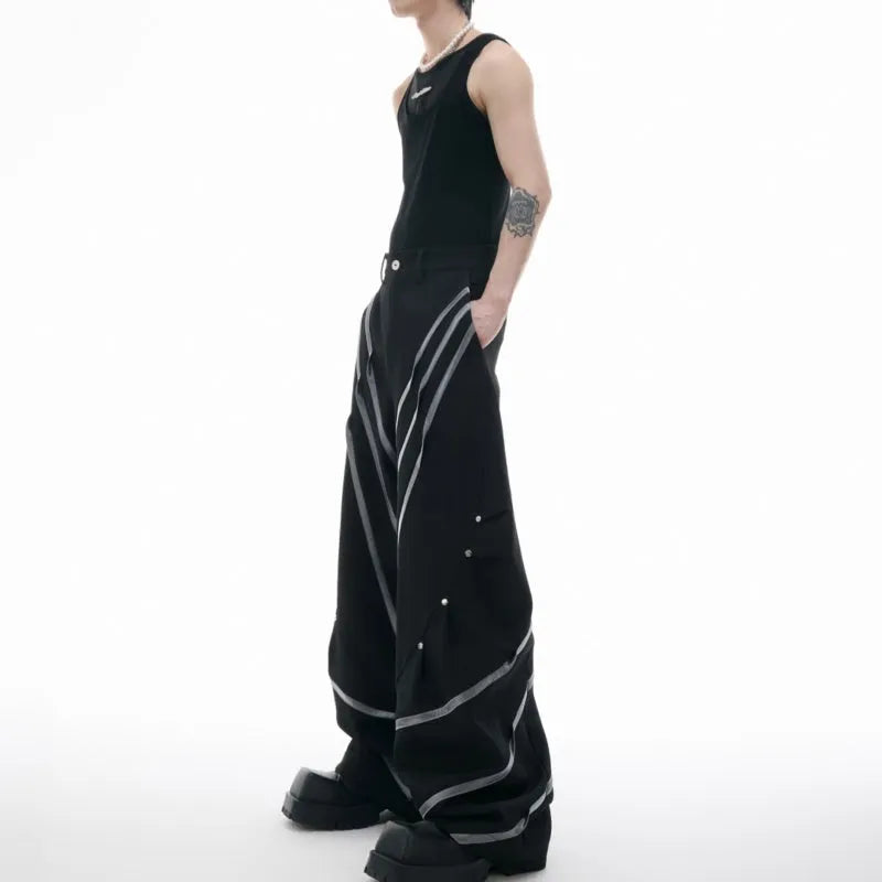 Men's black trousers with deconstructed three-dimensional cutting and metal rivets on the pleats