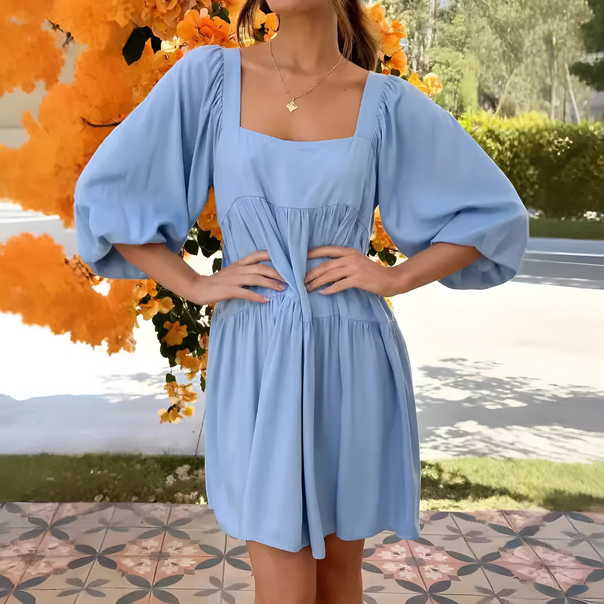 Orange children's backless dress with square collar and puff sleeves on hanger