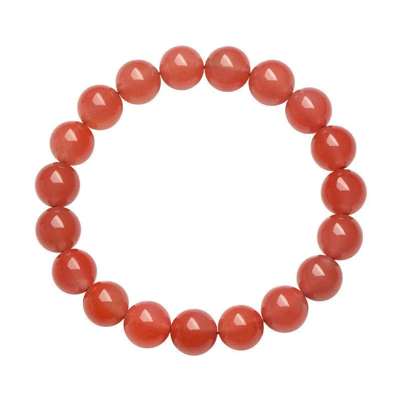 Natural cherry red agate bead bracelet with polished stones on a wrist, showing colour variation and secure clasp.