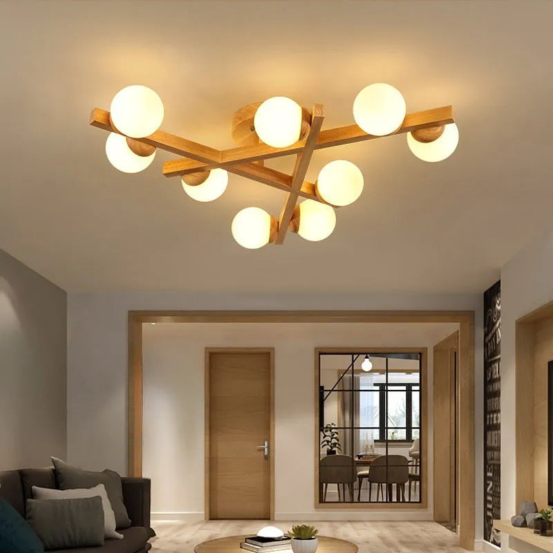 Scandinavian wooden-style ceiling light with three adjustable black lamp heads on angled arms