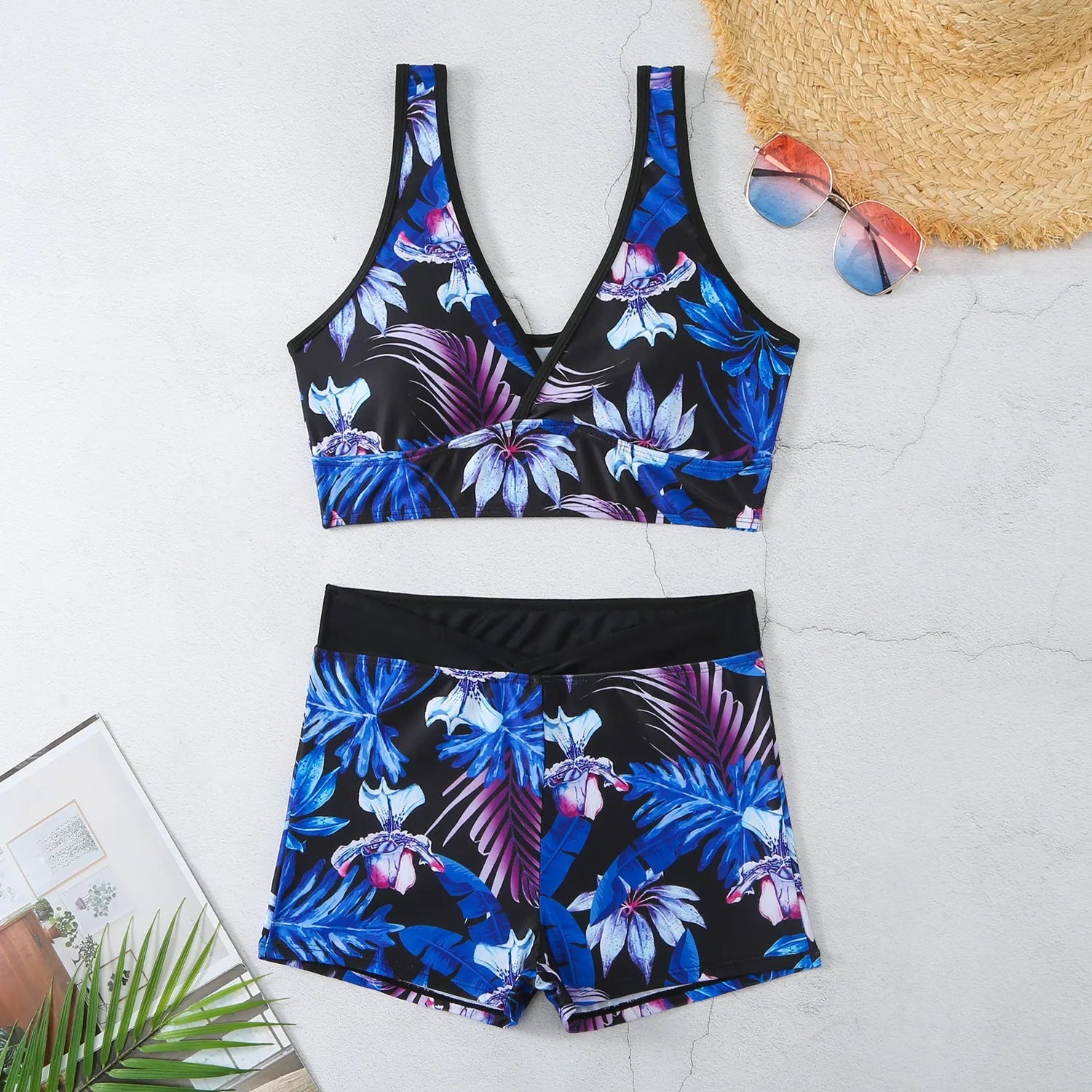 Women's two-piece swimsuit with sleeveless top and printed boxer brief bottoms in a multi-colour pattern.