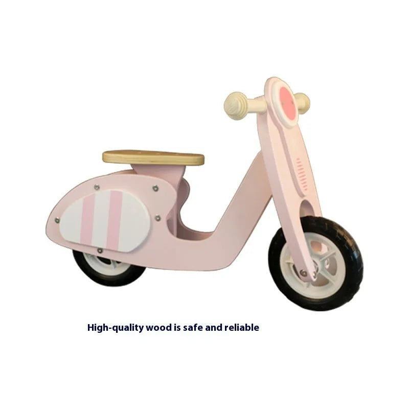 Pink wooden balance scooter for toddlers and children with 10-inch wheels.