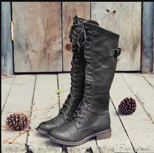 Black women's high leg boots with a low chunky heel and round toe made from artificial PU.