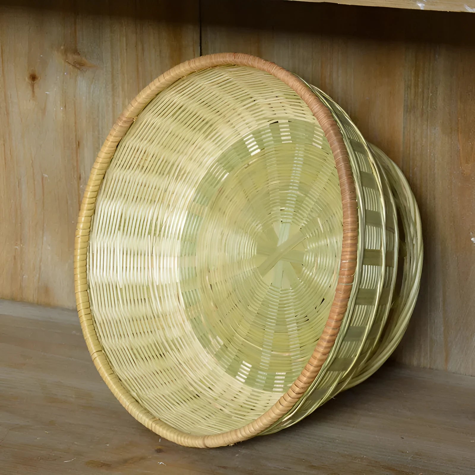 Handmade natural bamboo storage basket showing woven texture in three available sizes