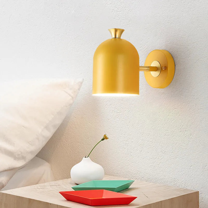 Blue touch control single-head wall lamp with mirror front, mounted beside a bed.