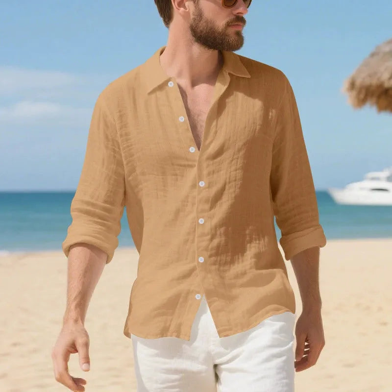 A man wearing a loose-fit light blue linen casual shirt with a non-iron finish, buttoned front and standard collar.