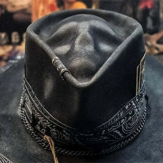 Handmade denim-blue wool felt skull hat with embroidered white skull on front and structured conical crown.