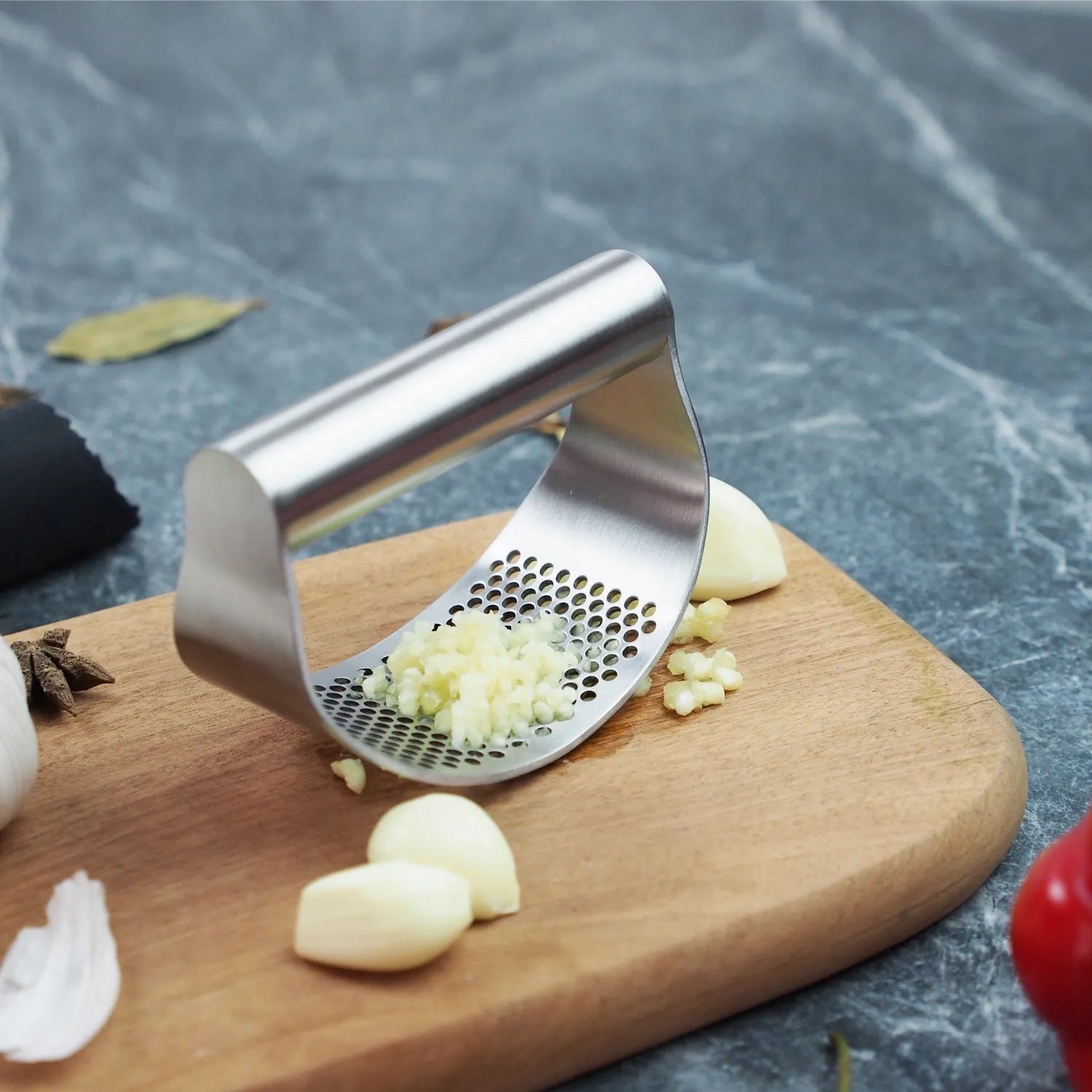 Stainless steel and PP plastic onion fork kitchen utensil for pressing garlic and vegetables.
