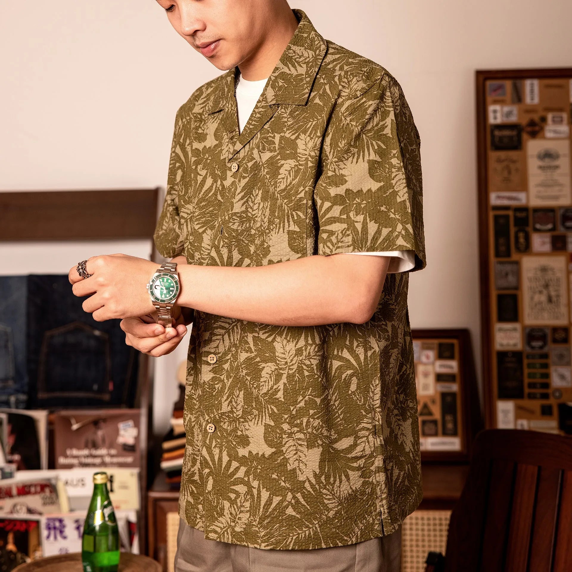 Vintage floral print seersucker shirt with a Cuban collar on a mannequin, shown in blue and green.