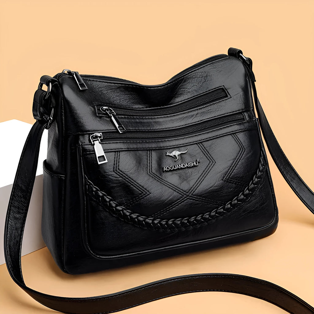 Soft black PU leather women's crossbody shoulder bag with a square shape on a white background.
