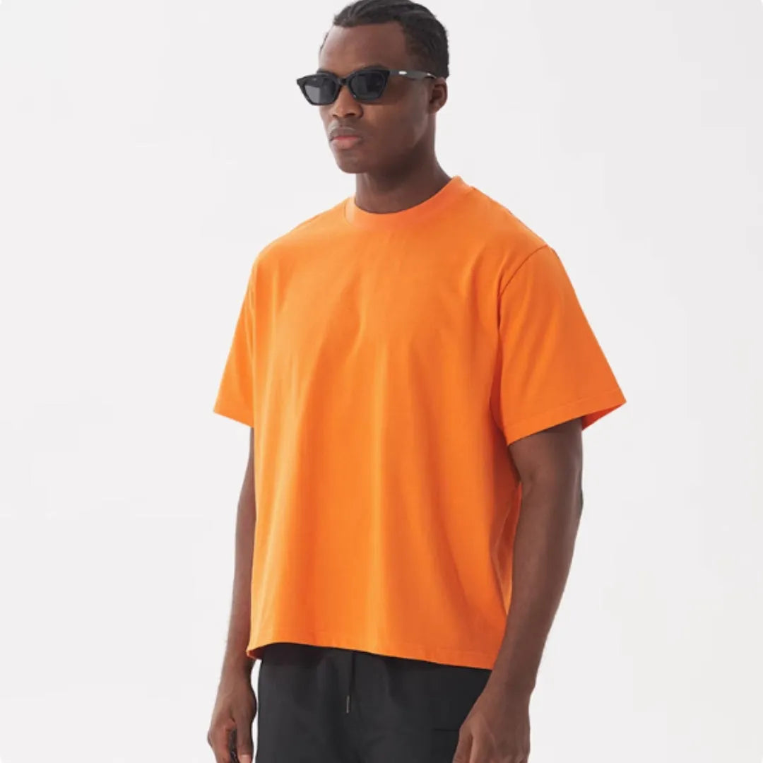 American style loose fit pure cotton T-shirt shown in apricot colour on a model.