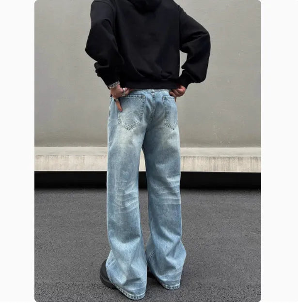 Men's blue straight leg jeans with whisker washing and visible stitching detail