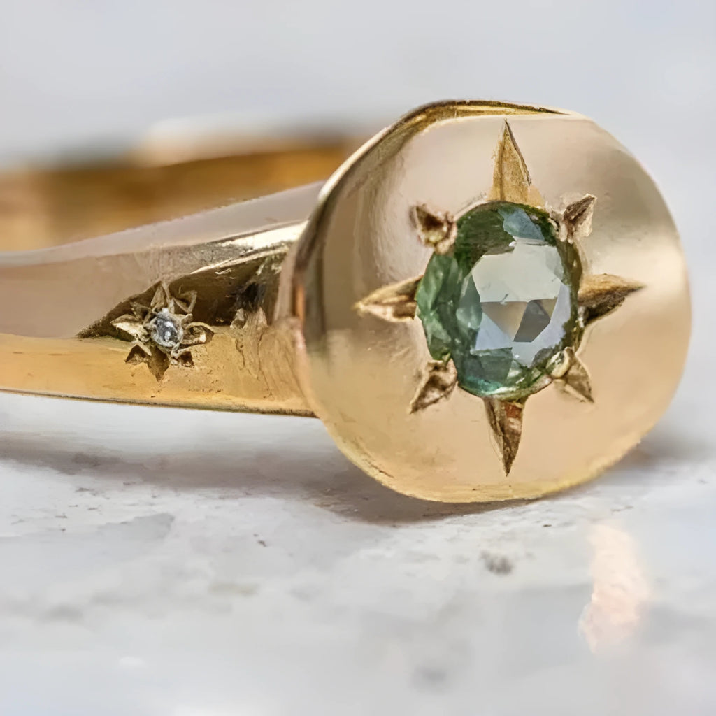 Golden oval ring with a central star-shaped zircon stone on an adjustable band.