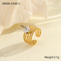 Geometric gold-coloured stainless steel ring with open mouth design on a plain background
